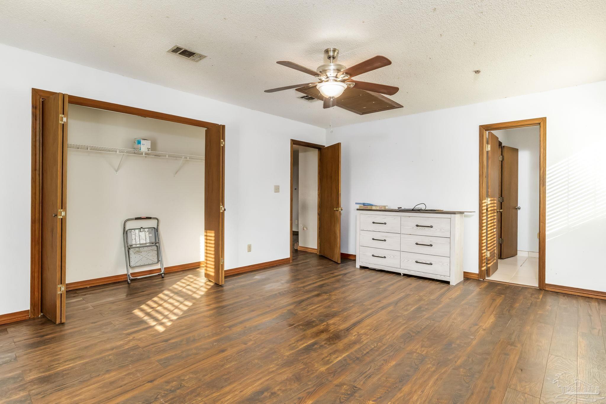 4616 B B Lowery Road Milton, FL 32583 - Photo 28 of 35 a view of an empty room with wooden floor and a window