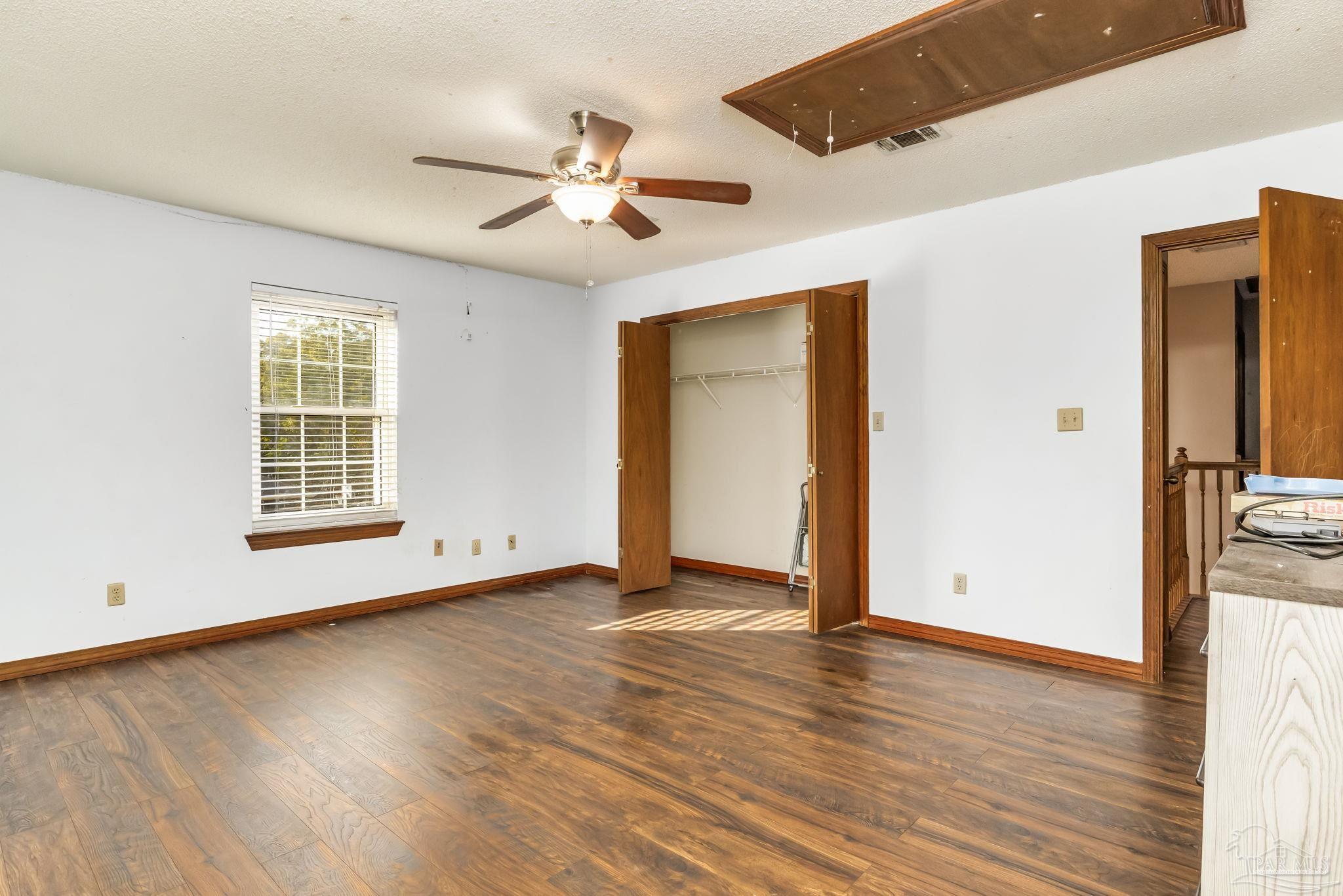 4616 B B Lowery Road Milton, FL 32583 - Photo 29 of 35 a view of an empty room with wooden floor and a window