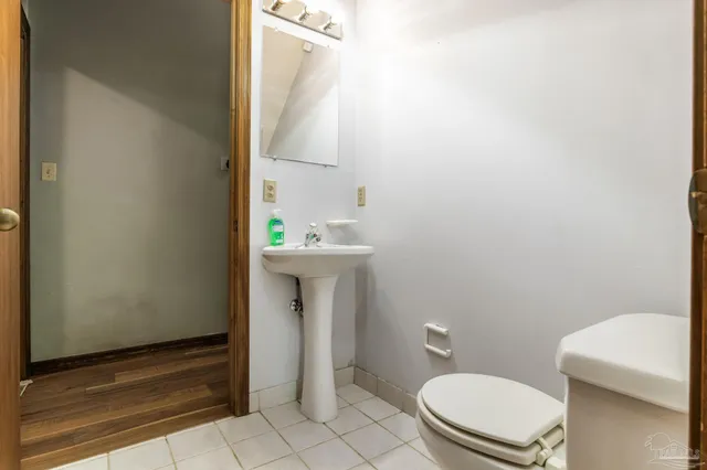 a bathroom with a sink a toilet and mirror