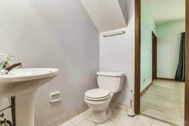 a white toilet sitting next to a bathroom sink