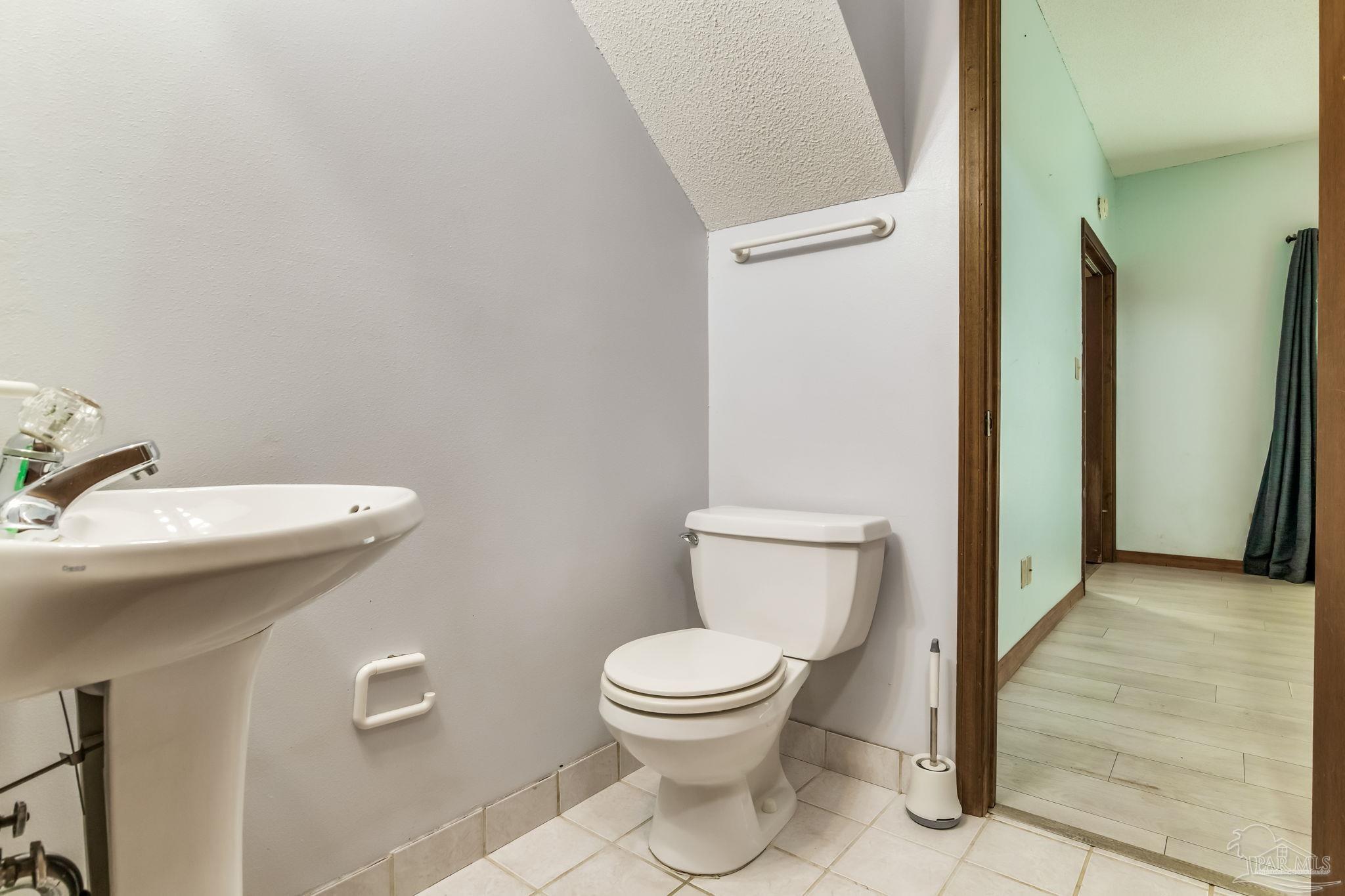 4616 B B Lowery Road Milton, FL 32583 - Photo 34 of 35 a white toilet sitting next to a bathroom sink