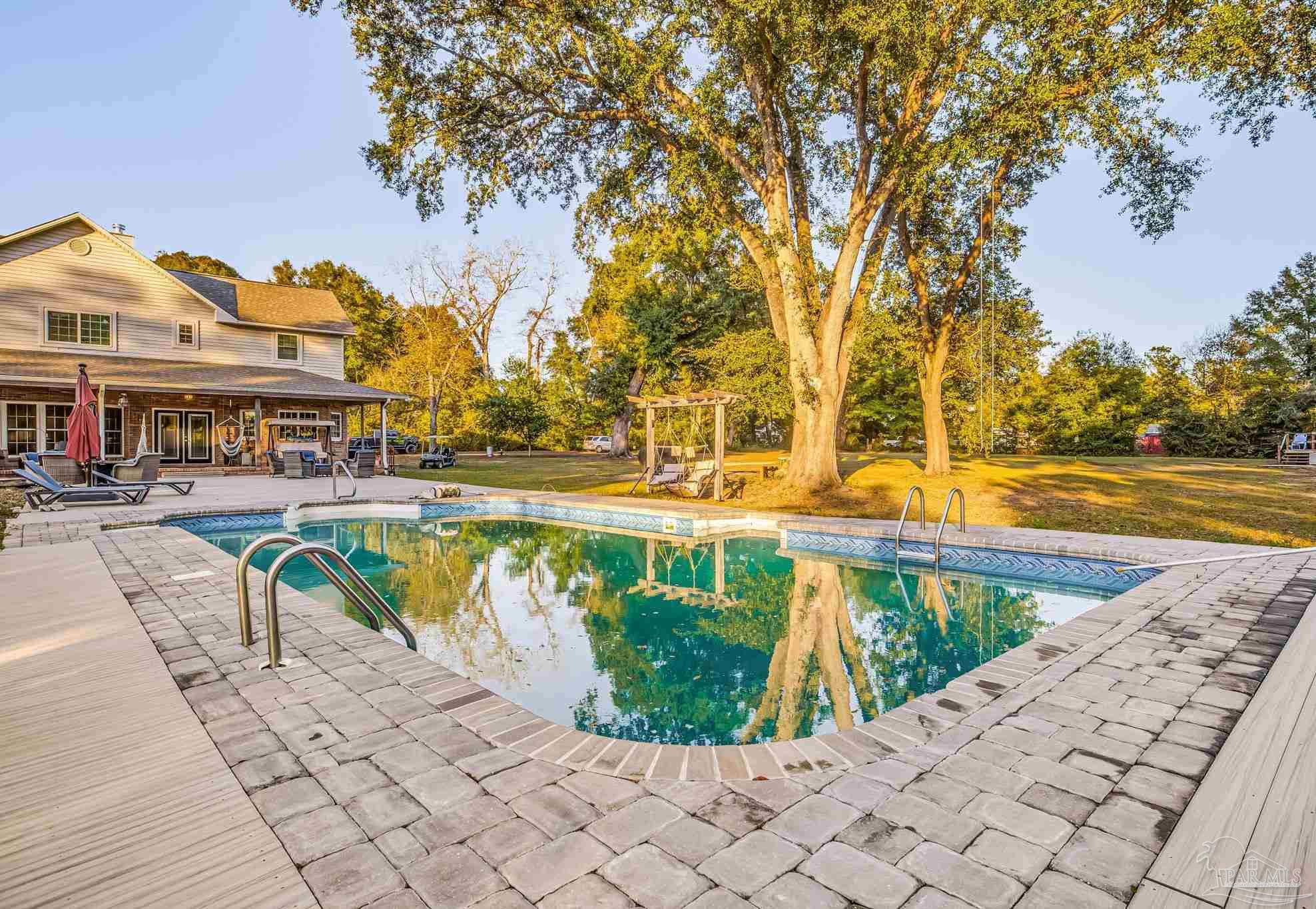 4616 B B Lowery Road Milton, FL 32583 - Photo 7 of 35 a view of swimming pool with outdoor seating and plants