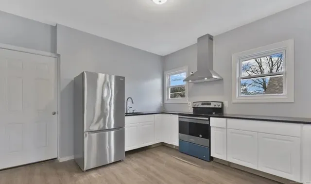 a kitchen with stainless steel appliances a refrigerator sink and stove