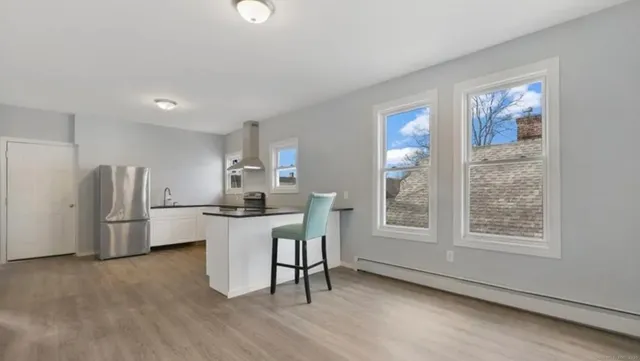 a kitchen with a refrigerator and windows