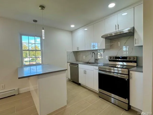 a kitchen with stainless steel appliances granite countertop a sink stove and cabinets