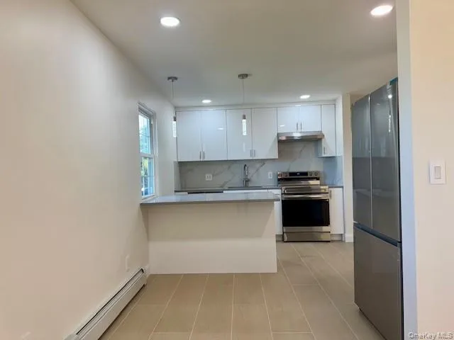 a kitchen with a sink and a refrigerator