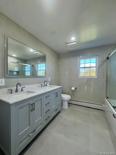 648 Old Country Road, Unit 2 Plainview, NY 11803 - Photo 5 of 13 a spacious bathroom with a double vanity sink a toilet and a mirror
