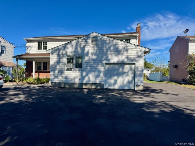 648 Old Country Road, Unit 2 Plainview, NY 11803 - Photo 9 of 13 a front view of a house with a yard