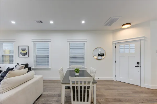 a living room with furniture a window and wooden floor