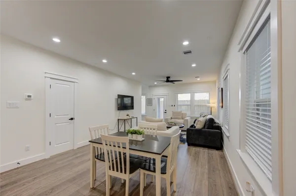 a living room with furniture a flat screen tv and a large window