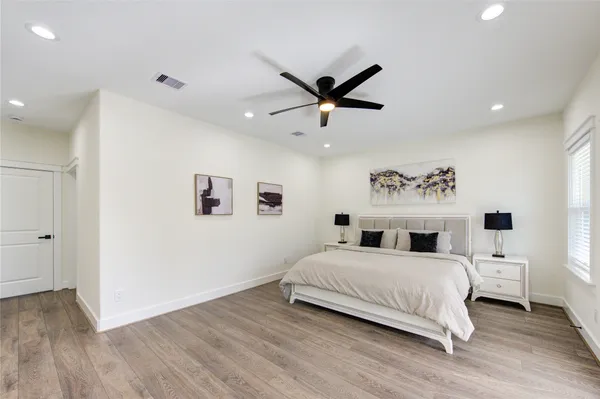 a bedroom with a large bed and a window