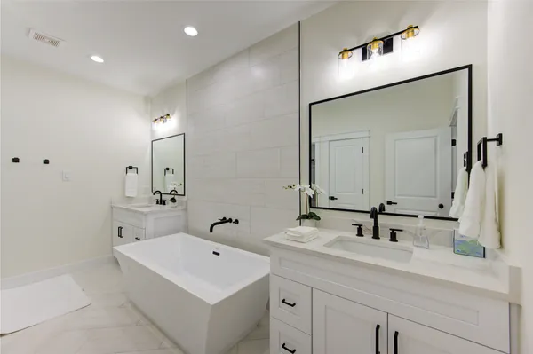 a bathroom with a sink a mirror and a shower