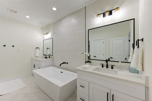 a bathroom with a sink a mirror and a shower