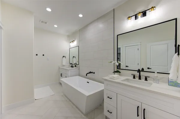 a bathroom with a double vanity sink and mirror