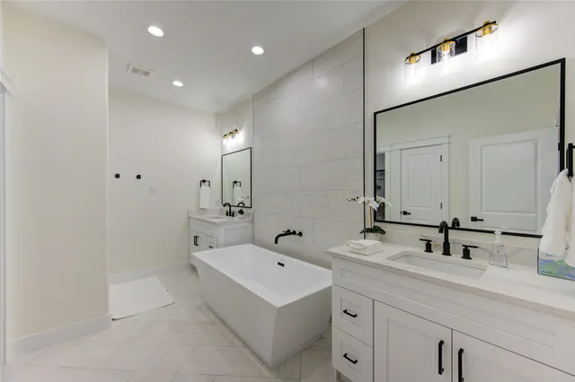 a bathroom with a double vanity sink and mirror