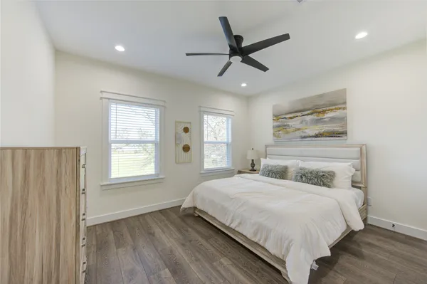 a bedroom with a large bed and a window