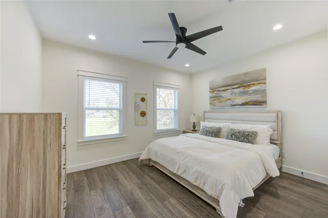 a bedroom with a large bed and a window