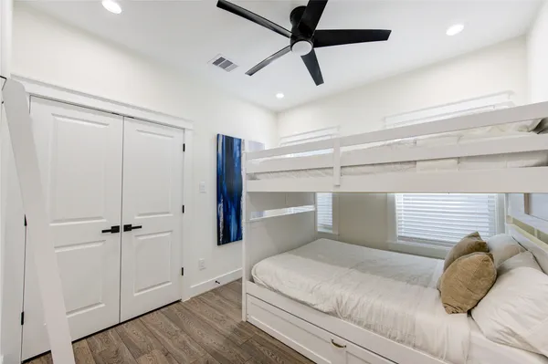 a bedroom with a bed and a ceiling fan