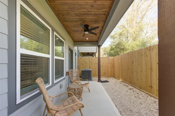 a balcony view with a large window and furniture