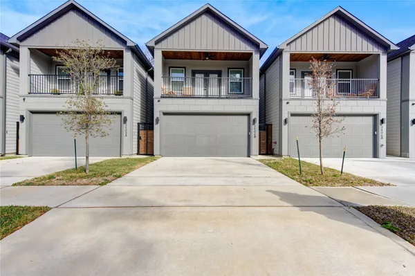 a front view of a house with a garden and pathway