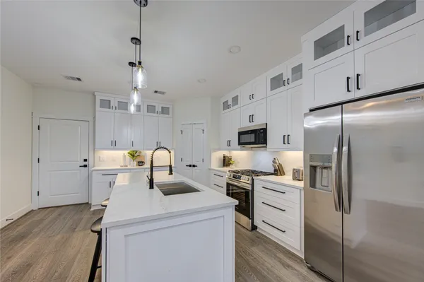 a kitchen with refrigerator a sink and cabinets