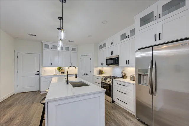 a kitchen with refrigerator a sink and cabinets