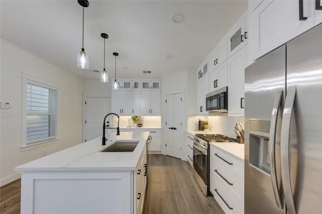 a kitchen that has a lot of cabinets and refrigerator