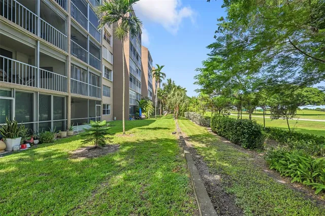 a view of a house with a yard and plants