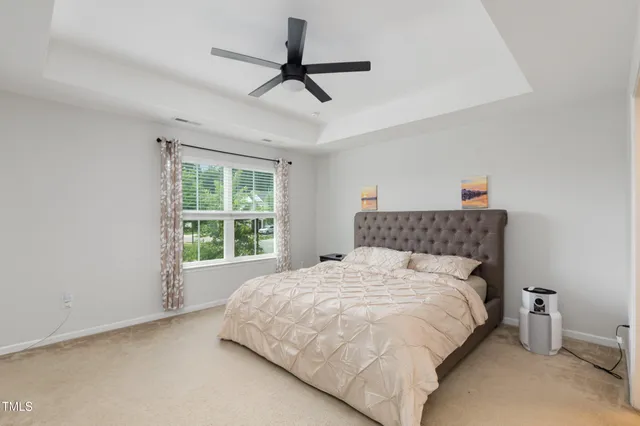 a bedroom with a large bed and a large window