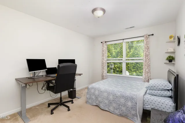 a bedroom with a workspace