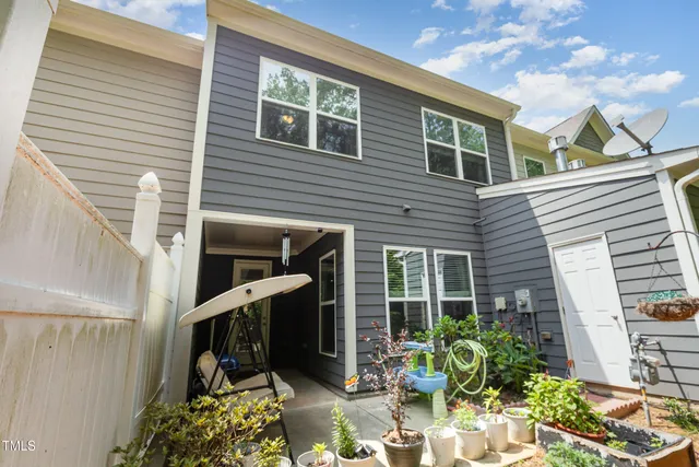 a view of a patio with table and chairs and potted plants