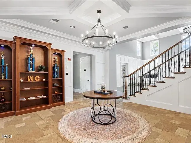 a view of a livingroom with furniture wooden floor and a chandelier