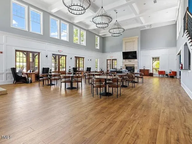 a view of dining room with furniture wooden floor and chandelier