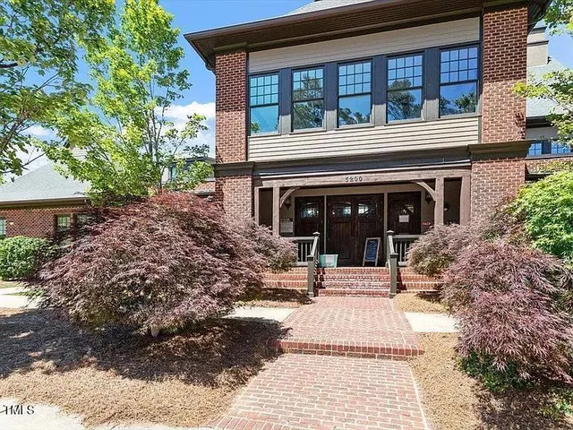 a view of house with yard and balcony