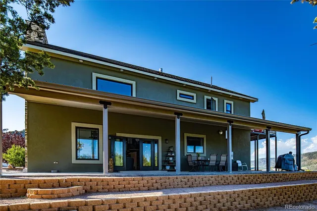 a living room with furniture a large window and a fireplace