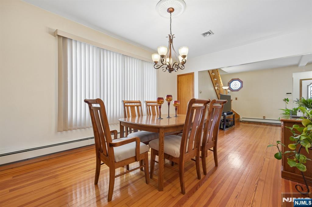 562 Valley Road Clifton, NJ 07013 - Photo 13 of 35 a view of a dining room with furniture wooden floor and chandelier