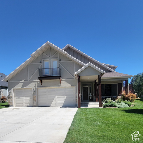 1182 North Canyon View Road, Unit 11 Midway, UT 84049 - Photo 1 of 1 View of front of property with driveway, a garage, a balcony, a front lawn, and stucco siding