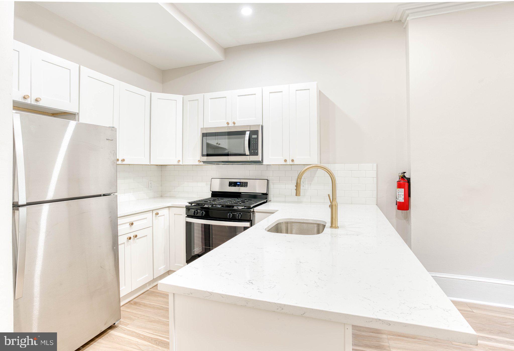 307 Kings Highway East, Unit 2 Haddonfield, NJ 08033 - Photo 12 of 21 a kitchen with stainless steel appliances a refrigerator sink and a stove