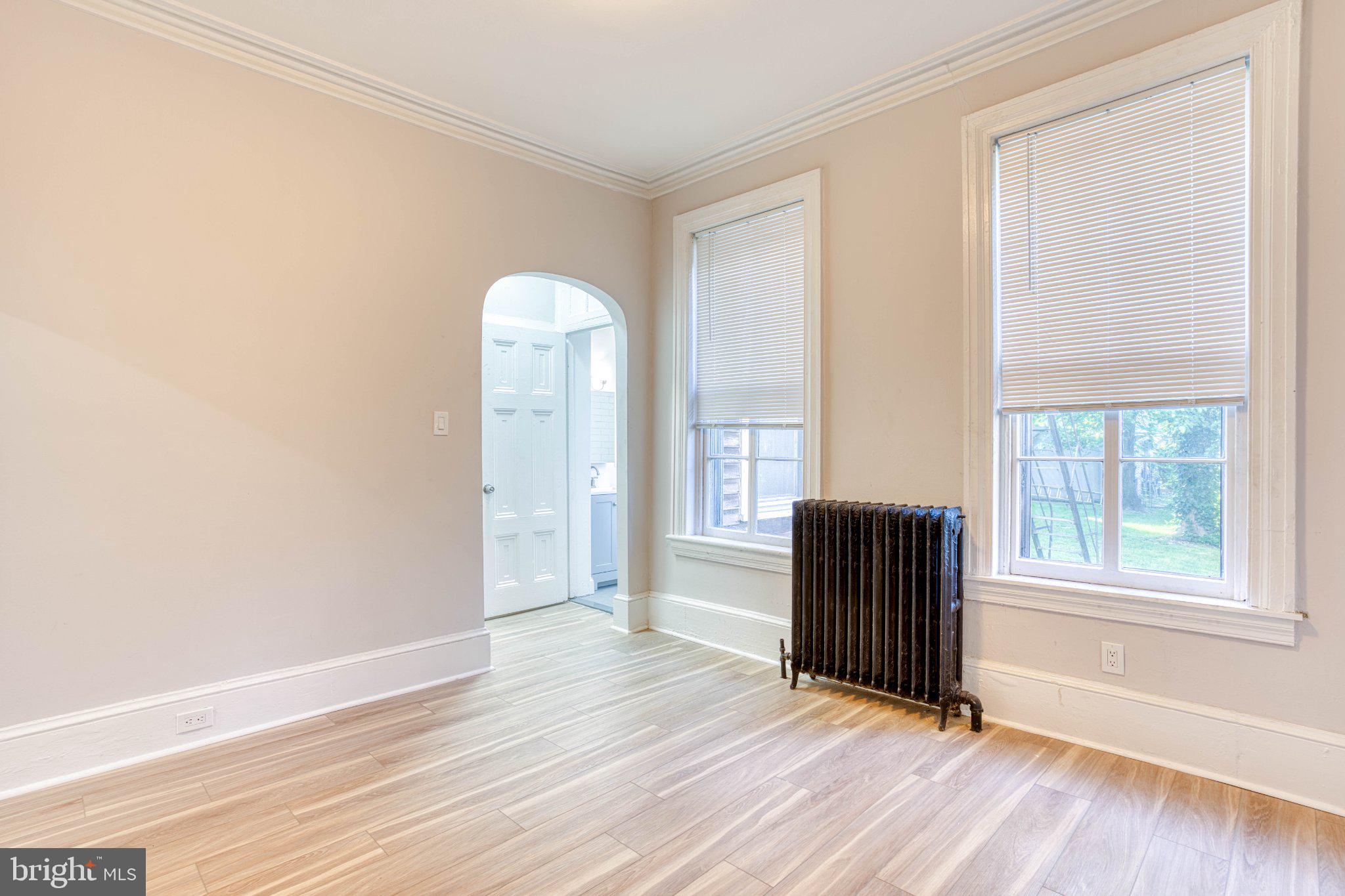 307 Kings Highway East, Unit 2 Haddonfield, NJ 08033 - Photo 18 of 21 an empty room with wooden floor and windows