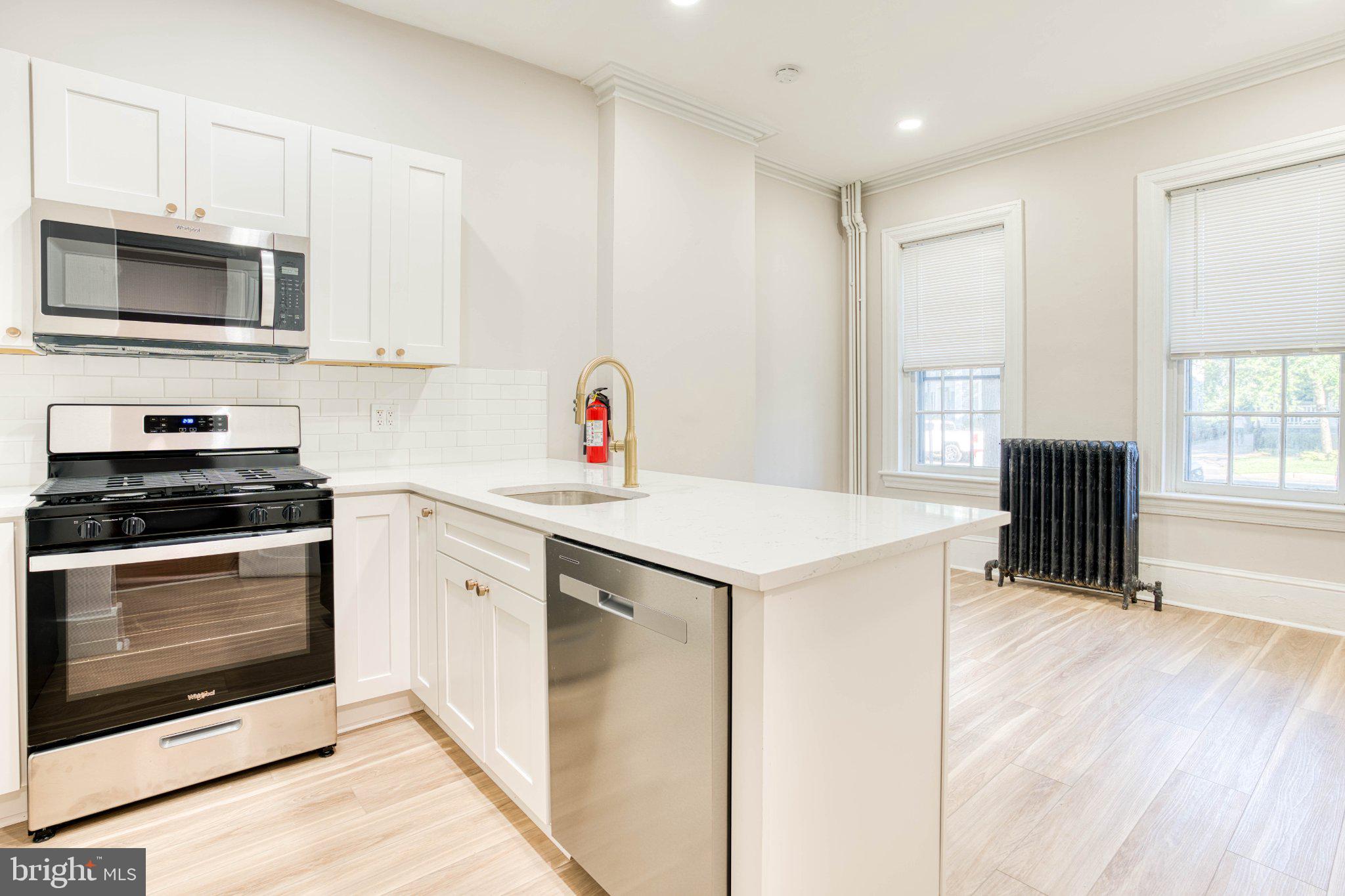 307 Kings Highway East, Unit 2 Haddonfield, NJ 08033 - Photo 5 of 21 a kitchen with stainless steel appliances a stove microwave and sink