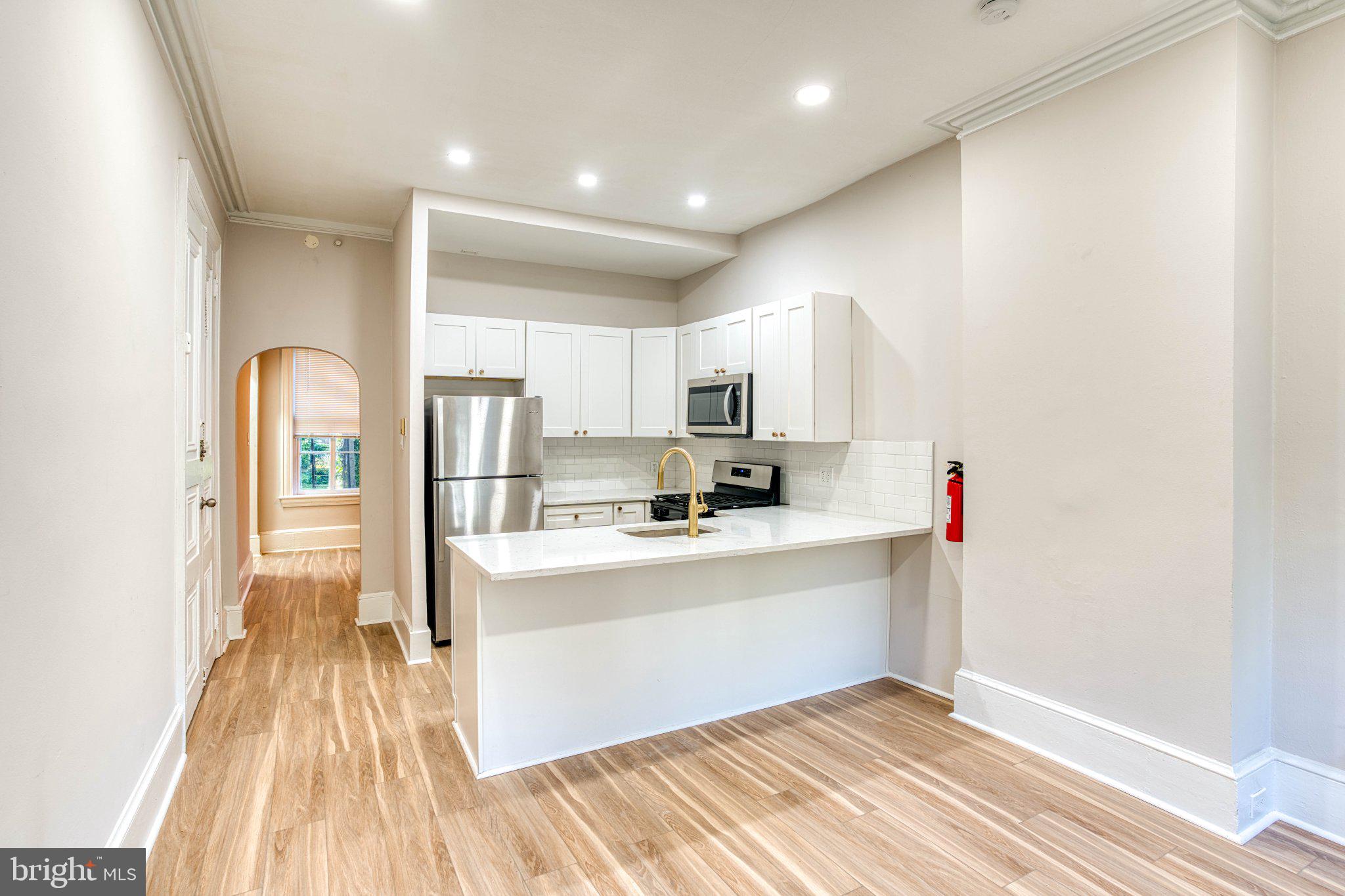 307 Kings Highway East, Unit 2 Haddonfield, NJ 08033 - Photo 6 of 21 a view of kitchen with cabinets and wooden floor