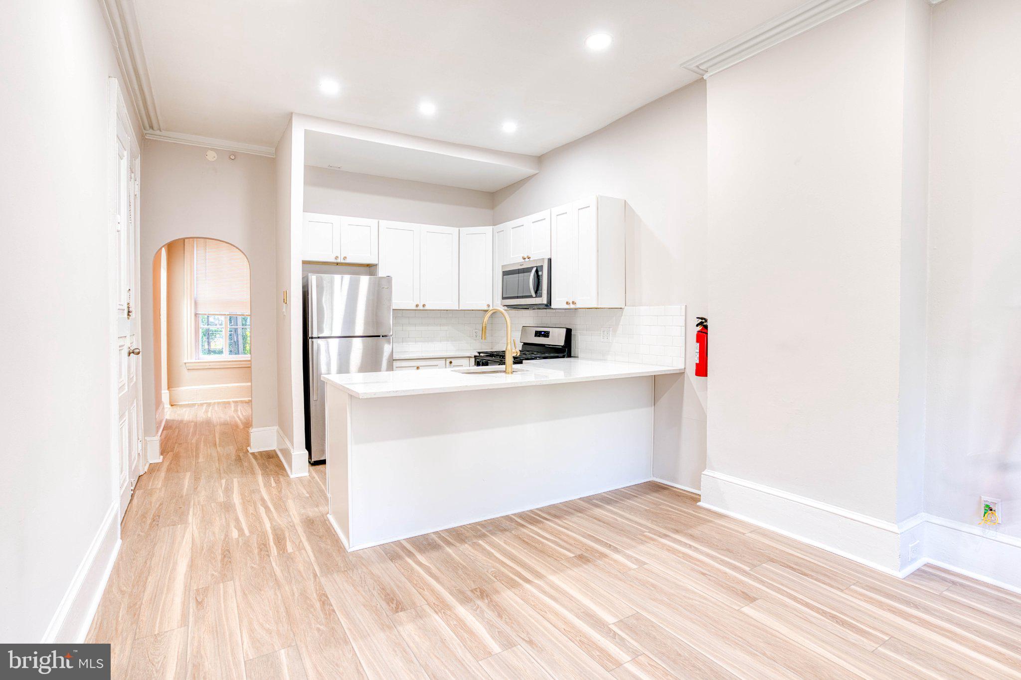 307 Kings Highway East, Unit 2 Haddonfield, NJ 08033 - Photo 8 of 21 a view of kitchen with wooden floor and electronic appliances