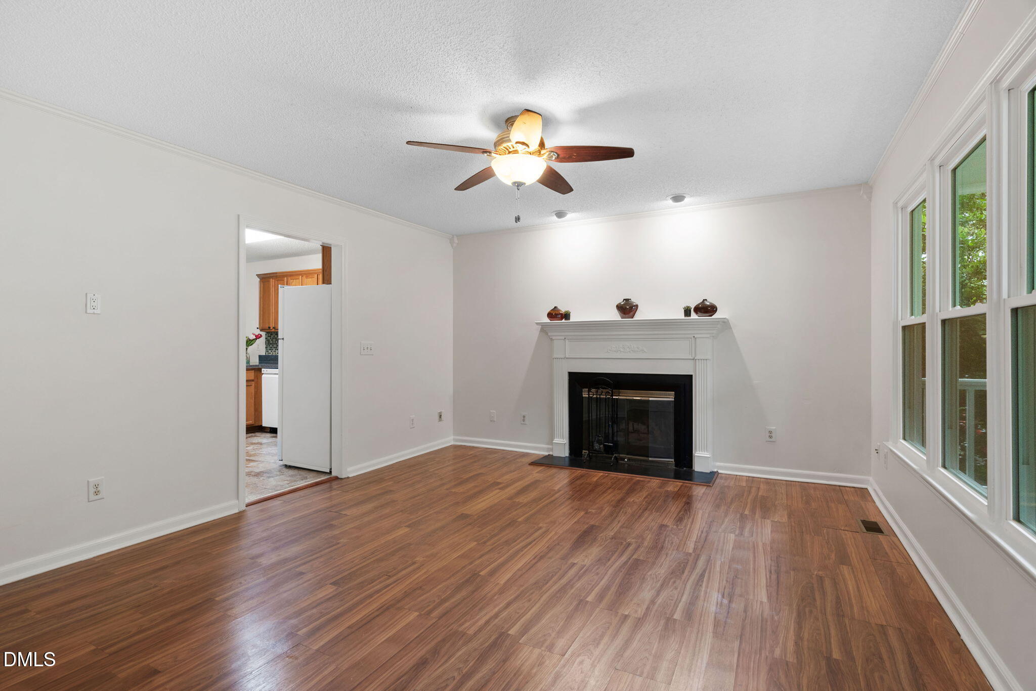 2724 Glastonbury Road Apex, NC 27539 - Photo 12 of 50 a view of empty room with wooden floor and fan