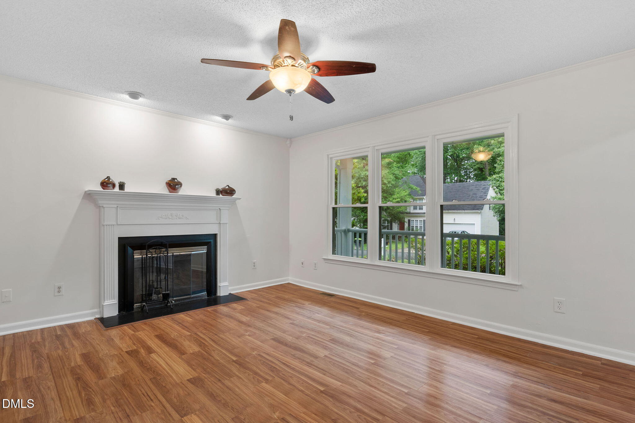 2724 Glastonbury Road Apex, NC 27539 - Photo 13 of 50 a view of an empty room with wooden floor fireplace and a window