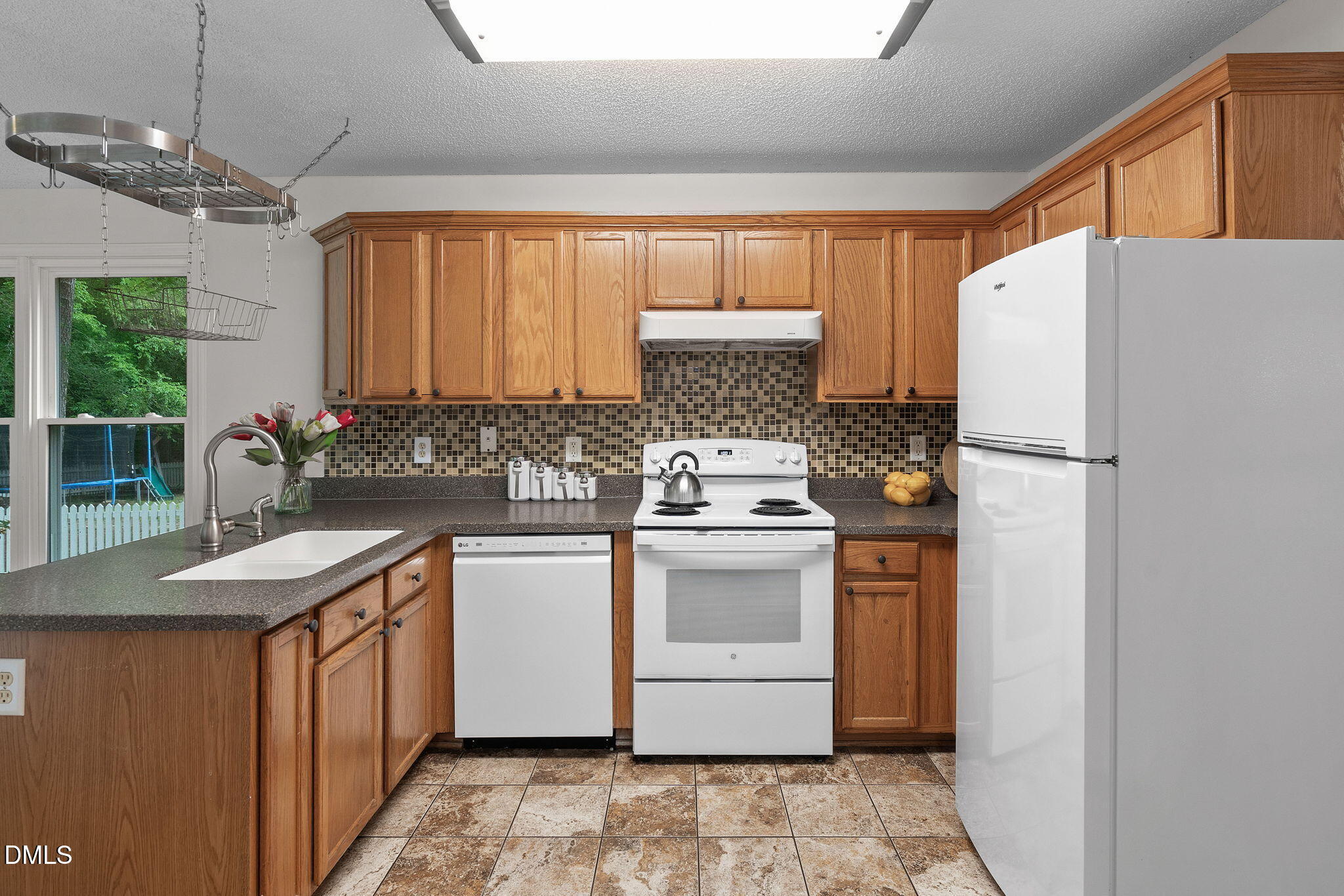 2724 Glastonbury Road Apex, NC 27539 - Photo 17 of 50 a kitchen with a sink stove and refrigerator