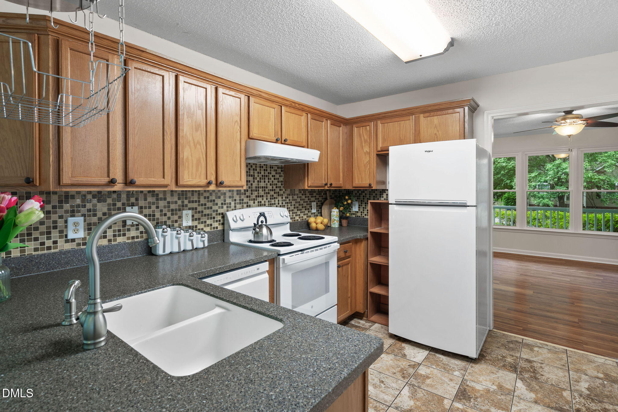 2724 Glastonbury Road Apex, NC 27539 - Photo 18 of 50 a kitchen with a refrigerator a sink and dishwasher a oven with wooden floor