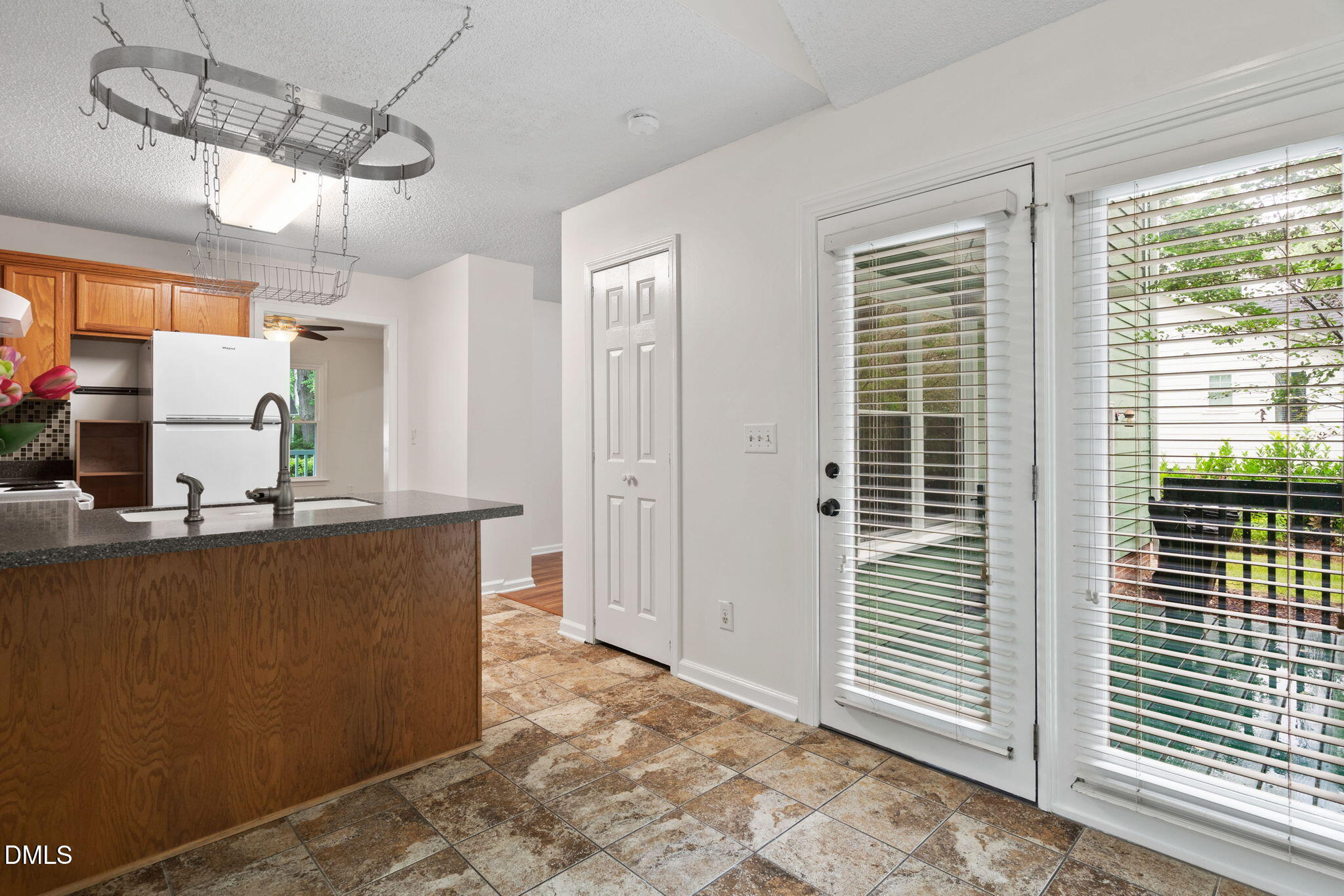 2724 Glastonbury Road Apex, NC 27539 - Photo 21 of 50 a view of a kitchen with a dining table & cabinets