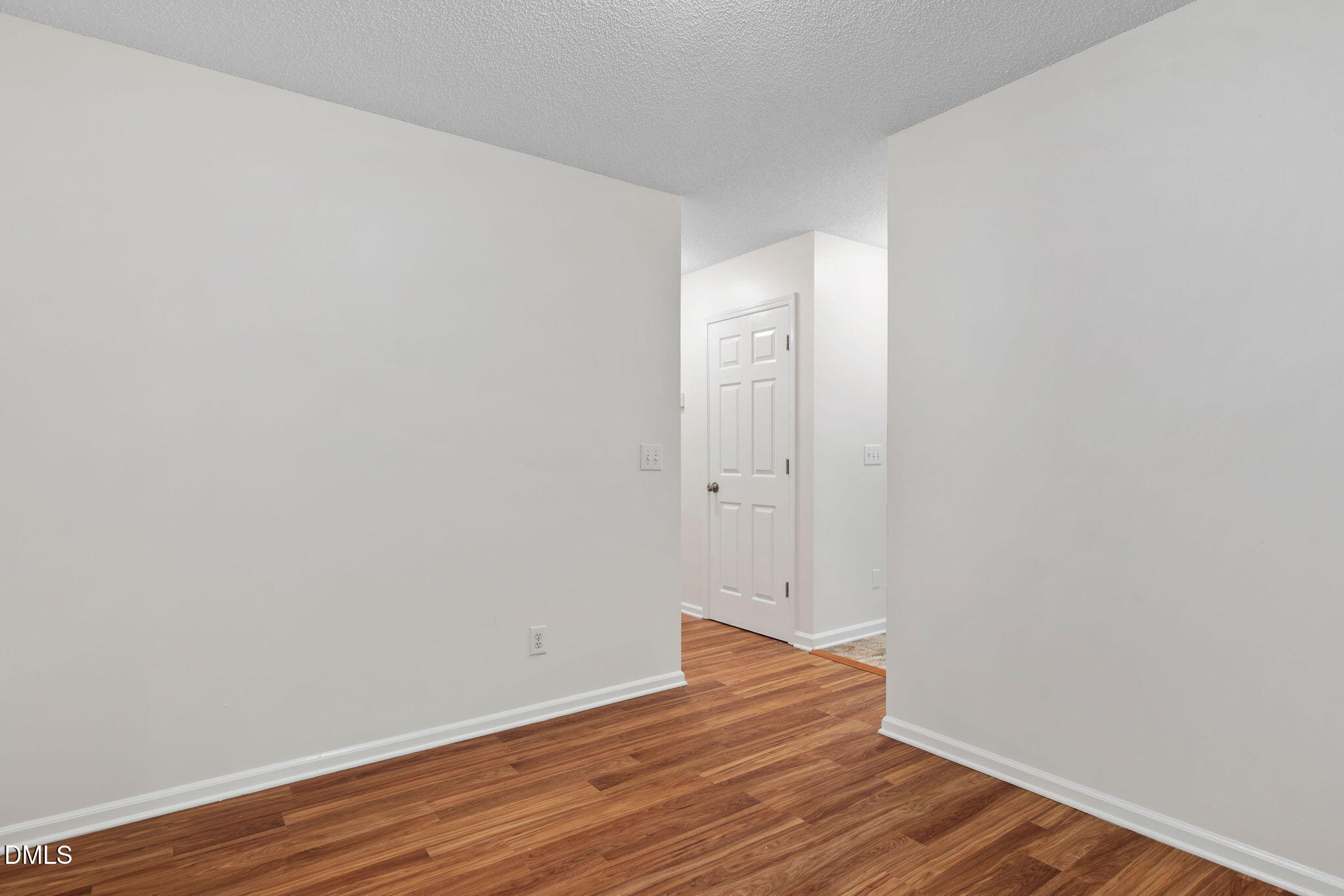 2724 Glastonbury Road Apex, NC 27539 - Photo 22 of 50 a view of an empty room with wooden floor
