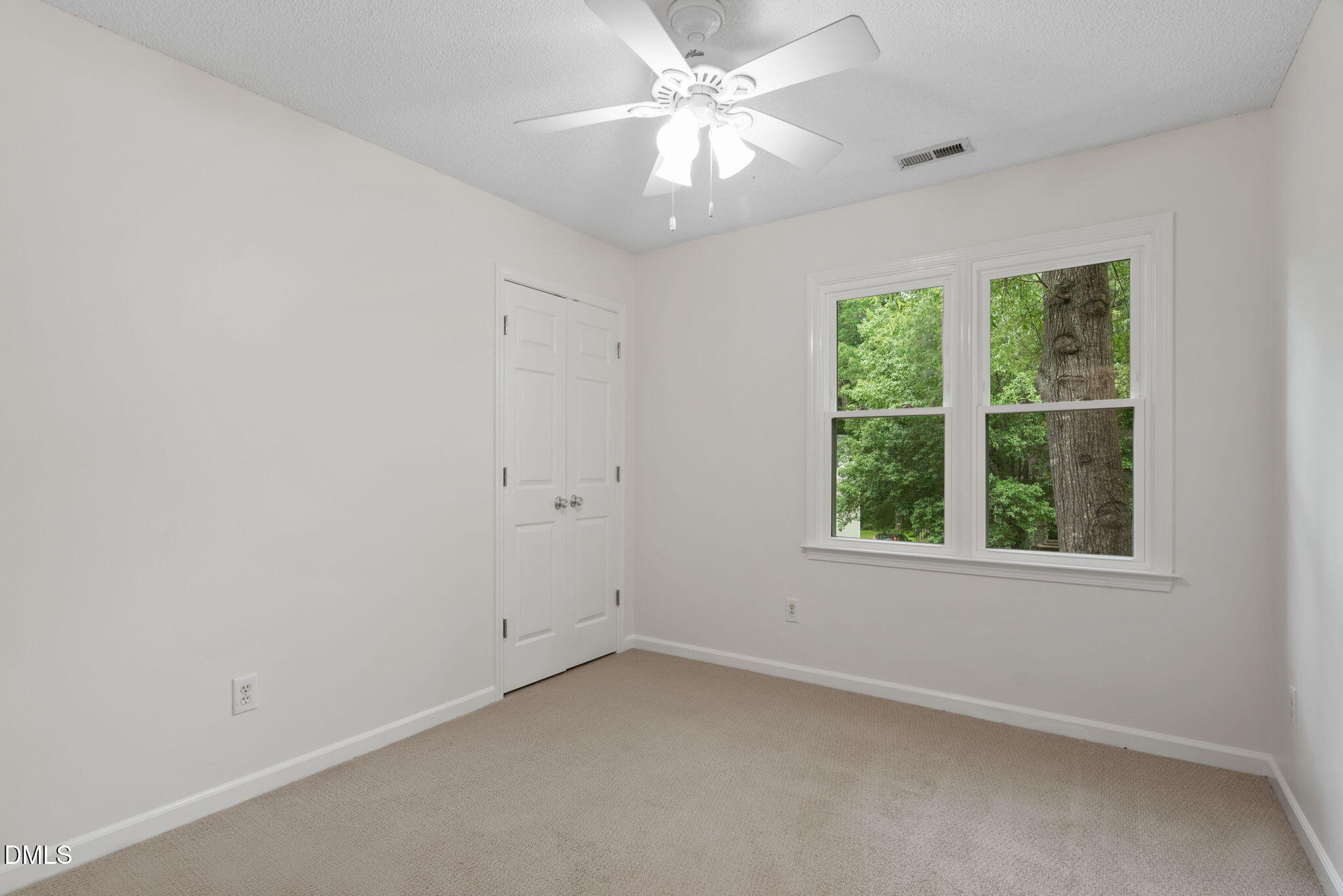 2724 Glastonbury Road Apex, NC 27539 - Photo 28 of 50 an empty room with a window and a fan