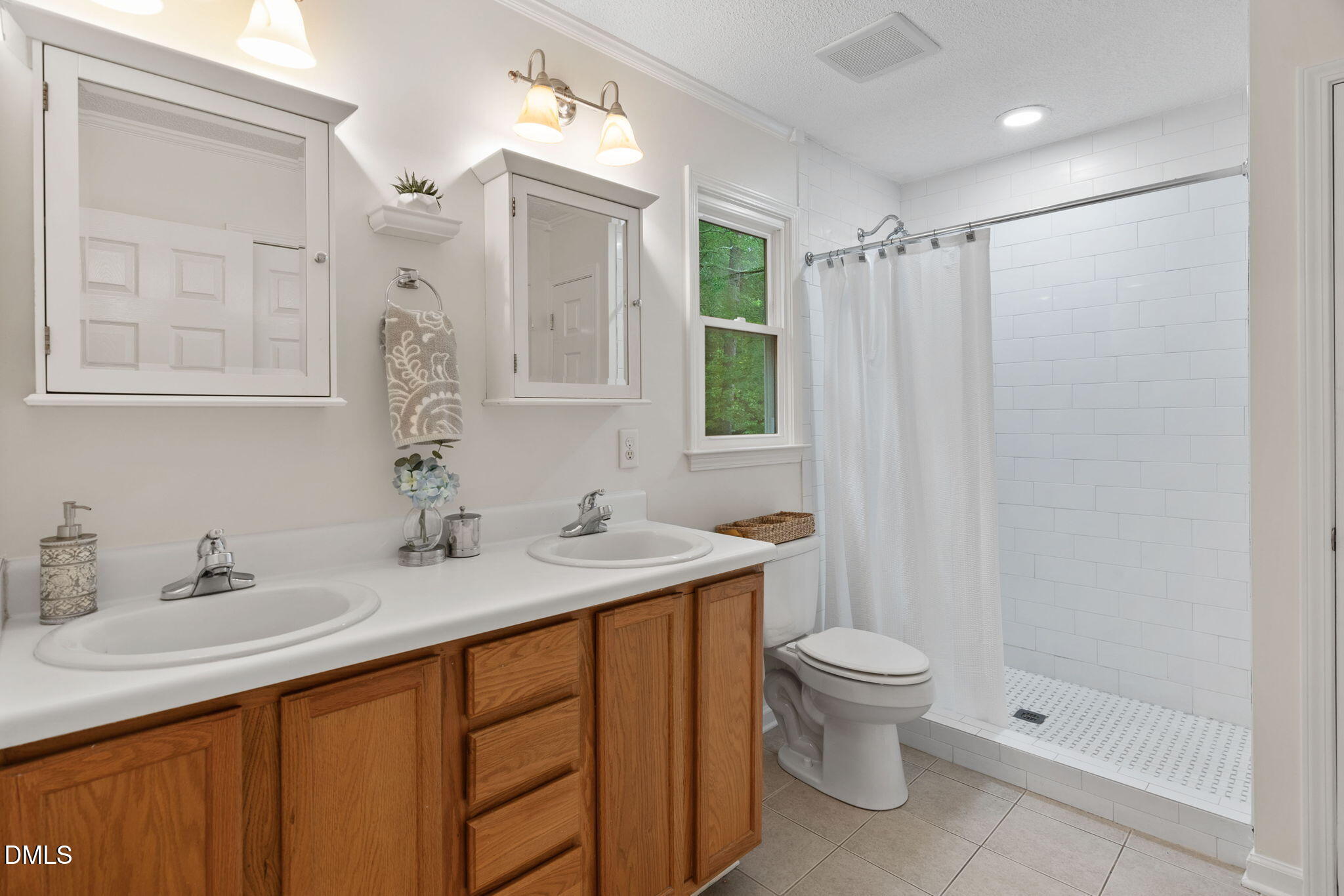2724 Glastonbury Road Apex, NC 27539 - Photo 32 of 50 a bathroom with a granite countertop sink toilet and shower